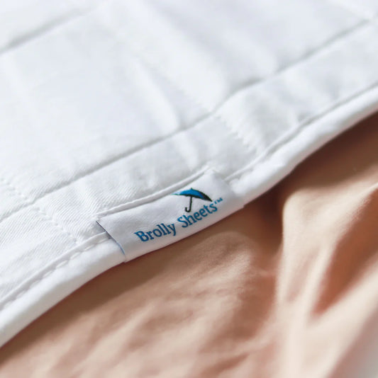 Close-up of Bolly Sheets label on a white sheet. Bedwetting Brolly Sheets - White