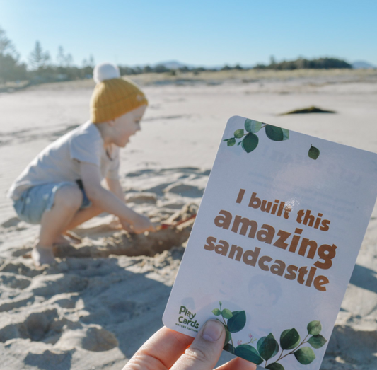 Child engaging with Nature Play Card at the beach – encourages screen-free, sensory-rich outdoor play