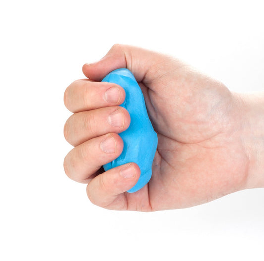 Hand squeezing blue CanDo Theraputty – used for improving grip strength, finger mobility, and hand coordination