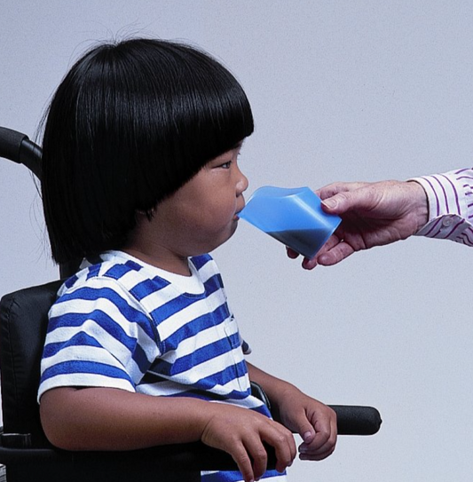 Child using ARK Flexi Cut-Out Cup – NDIS-eligible tool for feeding therapy and safe drinking with head and neck mobility support.