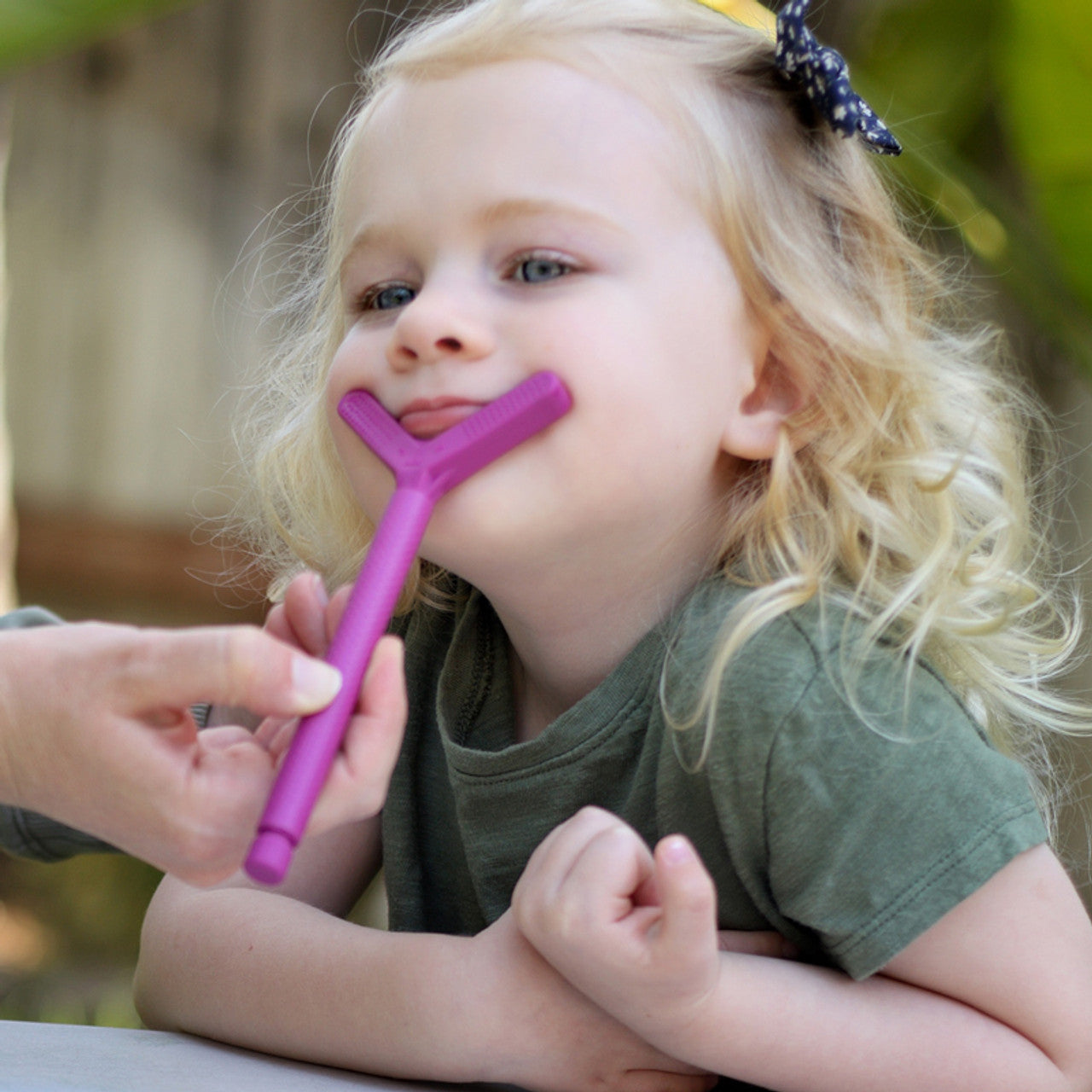 Girl using ARK Y Tip Bite Blocks for the Z-Vibe - Magenta. May be NDIS funded.