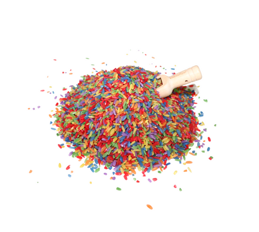 Colourful sensory rice scattered with wooden scoop, perfect for tactile play, fine motor development, and NDIS-related early childhood therapy