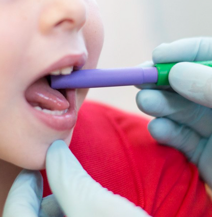 Therapist using ARK Smooth Bite Tube Tip with child during feeding therapy – may be approved for NDIS support.