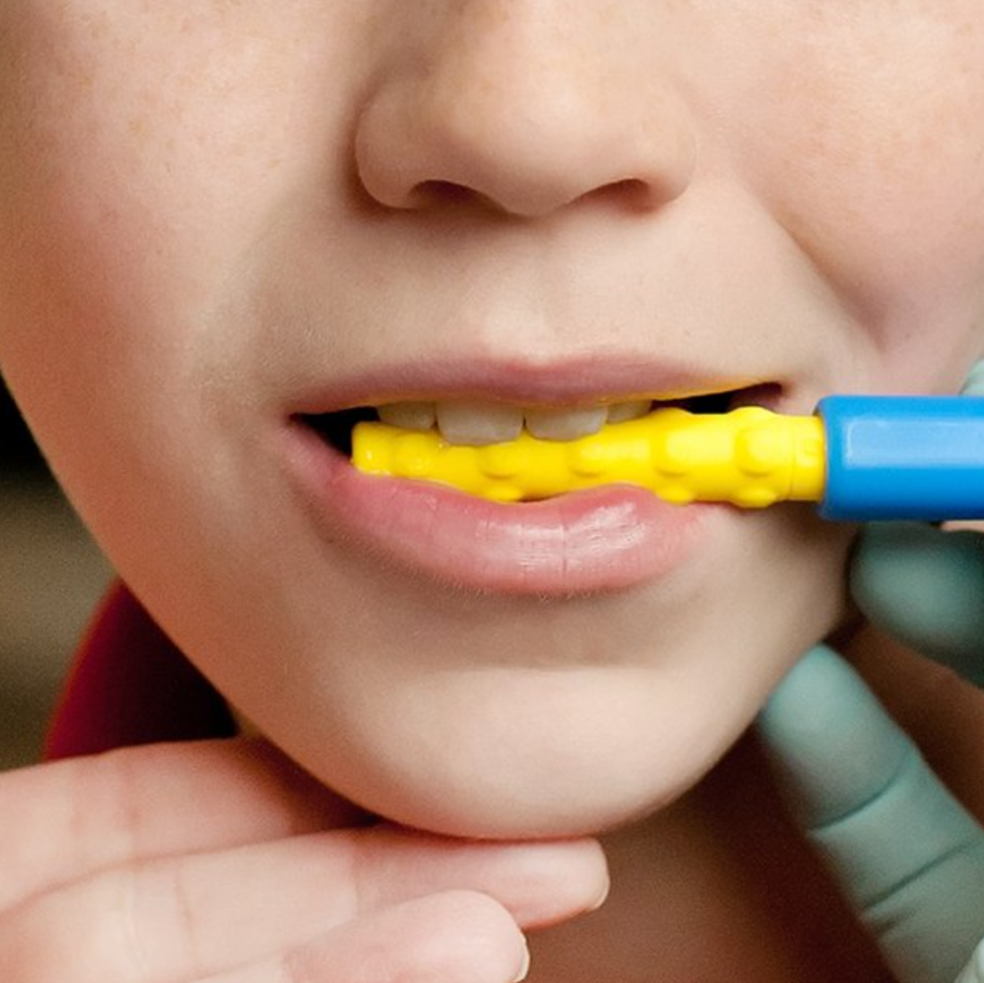 Child using ARK Bite-n-Chew XL Tip for chewing and jaw development – may be suitable for NDIS therapy plans