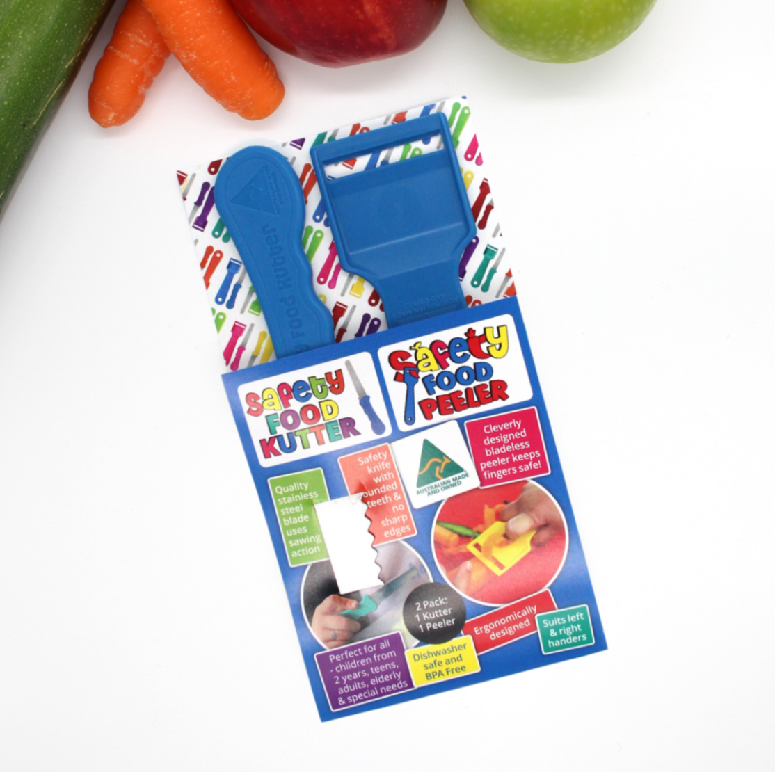 KiddieKutter child-safe knife and peeler twin pack displayed with colourful vegetables – promotes safe kitchen skills and independence; potentially NDIS-funded