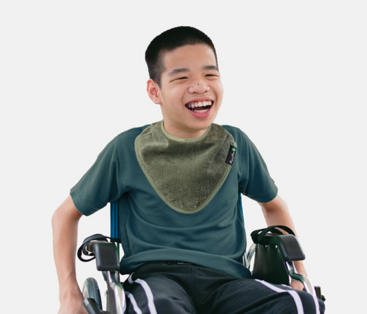 Youth Bandana Bib in khaki kid wearing a bandana bib.
