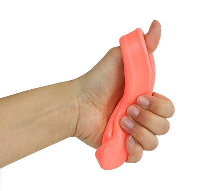 Hand squeezing red CanDo Theraputty – ideal for building light grip strength and finger coordination in therapy sessions