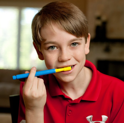 Child using the ARK Soft Brush Tip on a Z-Vibe handle for sensory-based oral input. Suitable for NDIS support plans