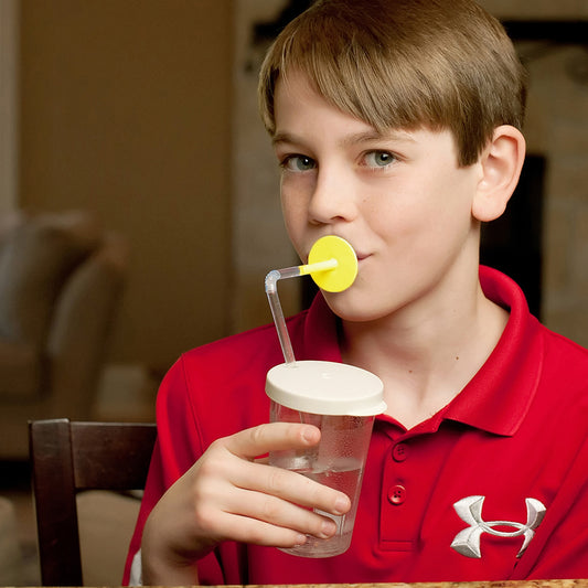 child in red shirt using ARK Sip-Tip® Adaptive Cup with Select-Flow Valve